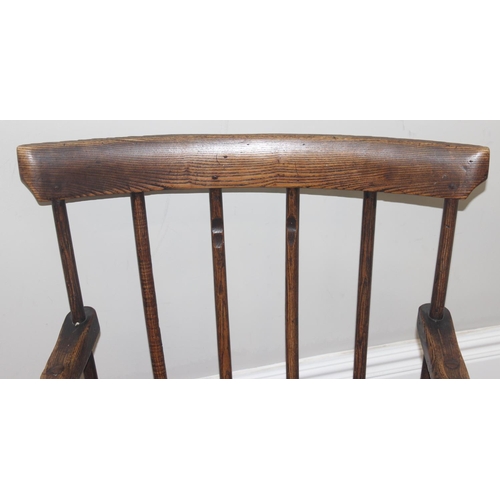 135 - A primitive antique Elm seated chair of comb-back form, possibly Welsh, 19th century or earlier, app... 