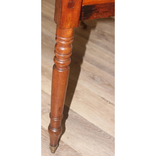 100 - A 19th century mahogany Pembroke table with turned legs and brass castors, approx 94cm (46cm when lo... 