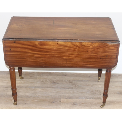 100 - A 19th century mahogany Pembroke table with turned legs and brass castors, approx 94cm (46cm when lo... 