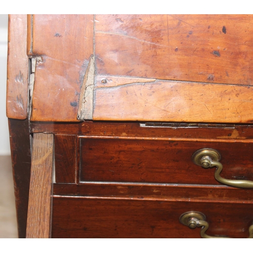 129 - A Georgian mahogany bureau with fitted interior, 4 long drawers with brass drop handles and bracket ... 