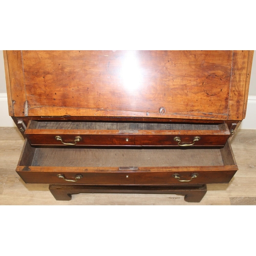 129 - A Georgian mahogany bureau with fitted interior, 4 long drawers with brass drop handles and bracket ... 