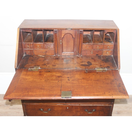 129 - A Georgian mahogany bureau with fitted interior, 4 long drawers with brass drop handles and bracket ... 