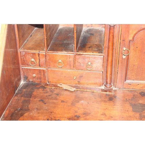 129 - A Georgian mahogany bureau with fitted interior, 4 long drawers with brass drop handles and bracket ... 