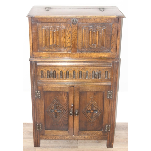 171 - A 17th century style oak cocktail cabinet with mirrored glass interior, likely by Ercol or Old Charm... 