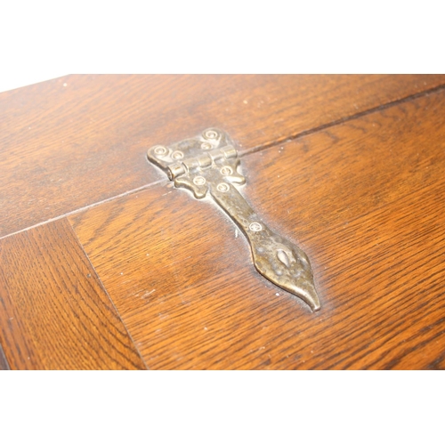 171 - A 17th century style oak cocktail cabinet with mirrored glass interior, likely by Ercol or Old Charm... 