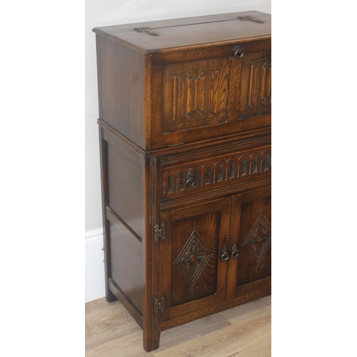 171 - A 17th century style oak cocktail cabinet with mirrored glass interior, likely by Ercol or Old Charm... 