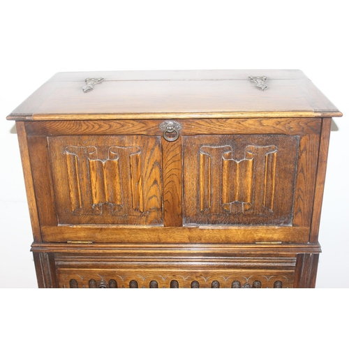 171 - A 17th century style oak cocktail cabinet with mirrored glass interior, likely by Ercol or Old Charm... 