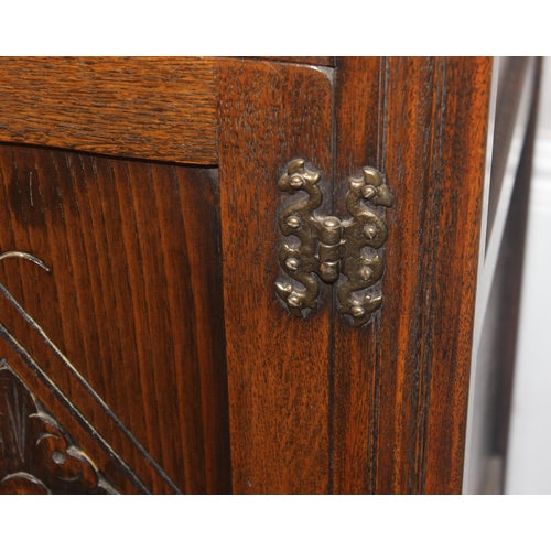 171 - A 17th century style oak cocktail cabinet with mirrored glass interior, likely by Ercol or Old Charm... 