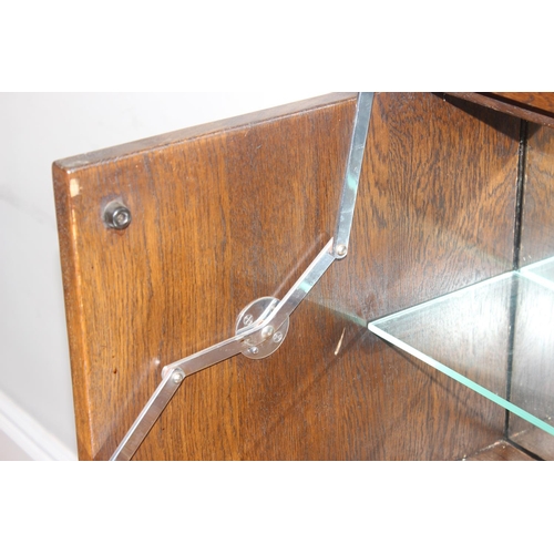 171 - A 17th century style oak cocktail cabinet with mirrored glass interior, likely by Ercol or Old Charm... 