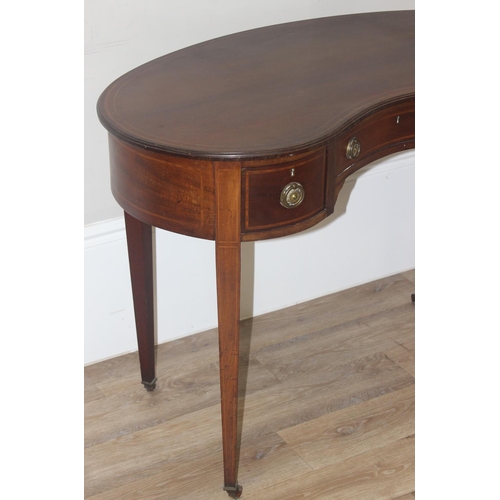 75 - An Edwardian Sheraton Revival period kidney shaped mahogany writing desk with 3 drawers, brass ring ... 