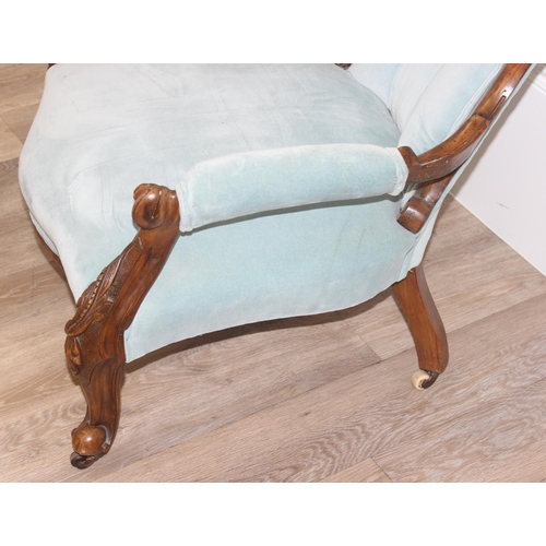 95 - A Victorian button backed nursing chair with turquoise upholstery and carved wooden exposed frame, a... 