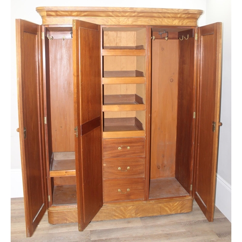 57 - A Victorian Satinwood triple wardrobe press, the mirror and panel doors enclosing 5 trays, 3 drawers... 