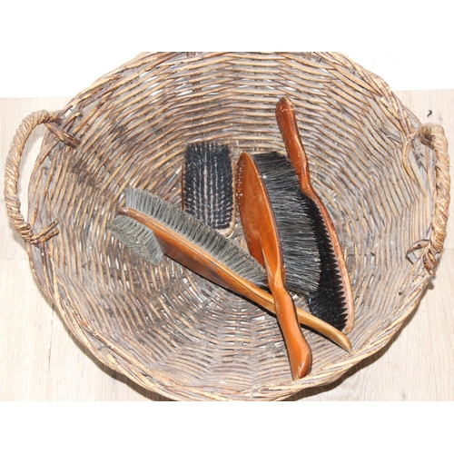 303 - Qty of assorted wicker items to inc a child's chair, 2 baskets and a qty of wooden clothes brushes e... 