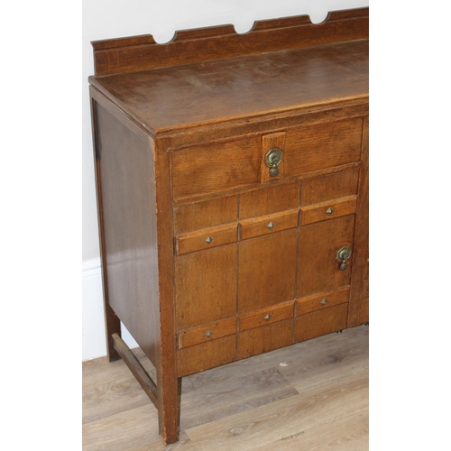 67 - A 17th century style oak sideboard with 2 drawers over 2 doors, brass drop handles, approx 122cm wid... 