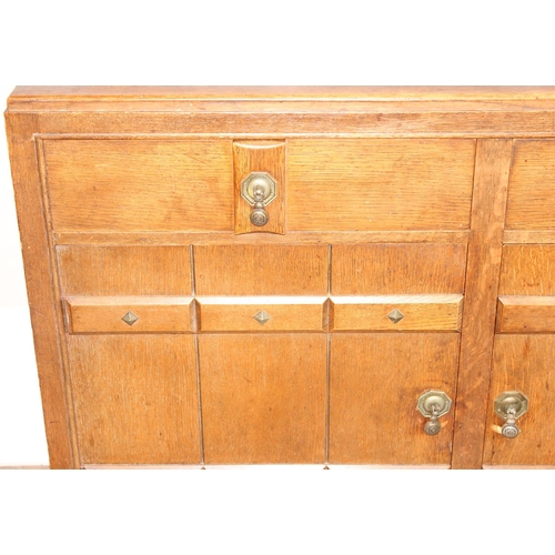 67 - A 17th century style oak sideboard with 2 drawers over 2 doors, brass drop handles, approx 122cm wid... 