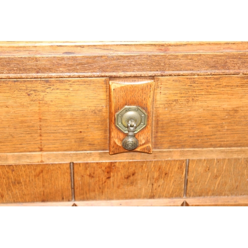 67 - A 17th century style oak sideboard with 2 drawers over 2 doors, brass drop handles, approx 122cm wid... 