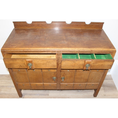 67 - A 17th century style oak sideboard with 2 drawers over 2 doors, brass drop handles, approx 122cm wid... 