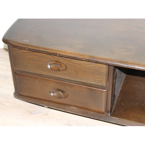 51 - An Ercol Minerva coffee table with 2 drawers, model 844, dark finish, approx 125cm wide x 54cm deep ... 