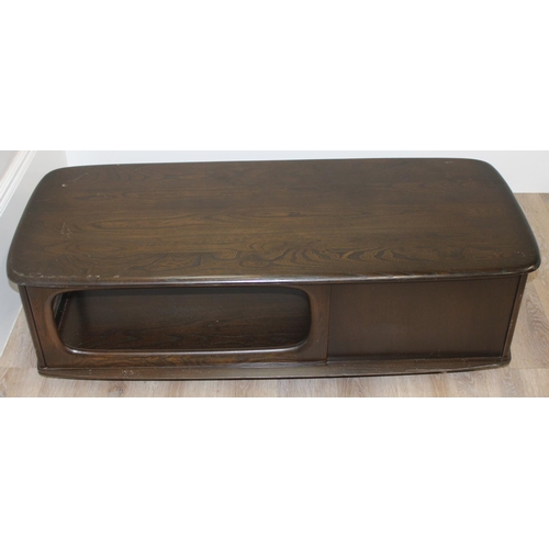 51 - An Ercol Minerva coffee table with 2 drawers, model 844, dark finish, approx 125cm wide x 54cm deep ... 