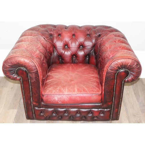 72 - A Chesterfield style distressed leather club chair, ox-blood red colouring, approx 108cm wide