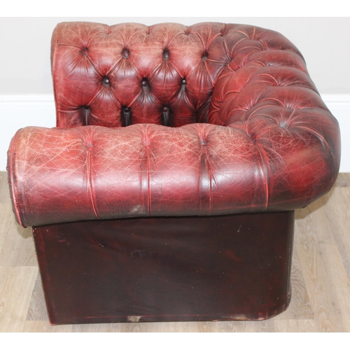 72 - A Chesterfield style distressed leather club chair, ox-blood red colouring, approx 108cm wide