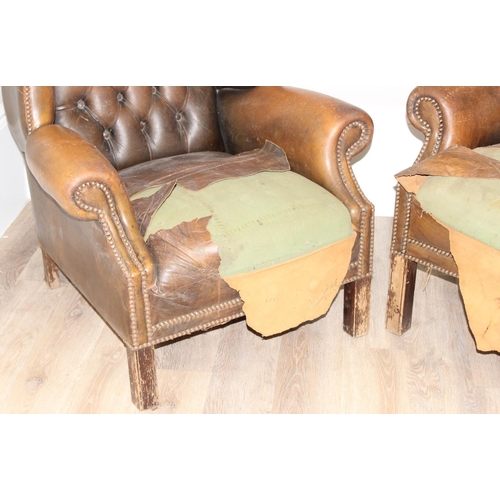 102 - A matched pair of antique style Chesterfield tan leather wingback club chairs for restoration