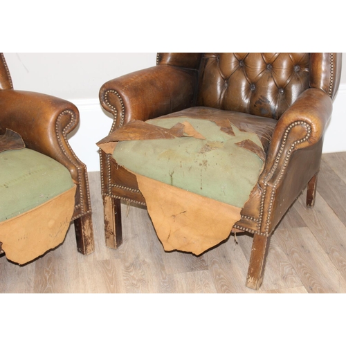 102 - A matched pair of antique style Chesterfield tan leather wingback club chairs for restoration