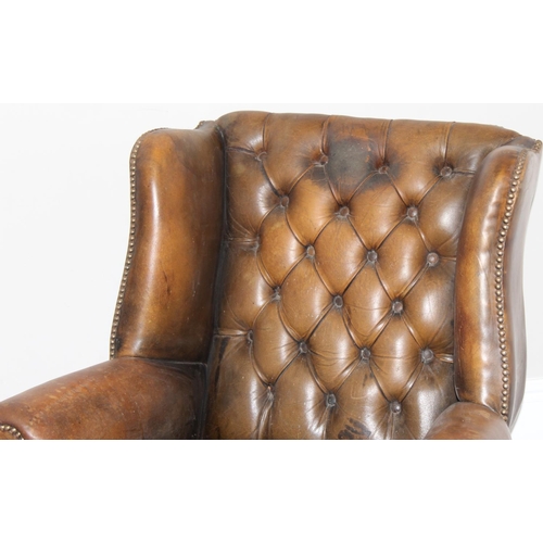 102 - A matched pair of antique style Chesterfield tan leather wingback club chairs for restoration