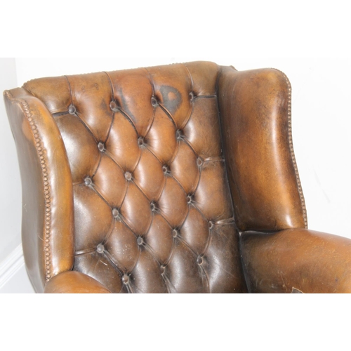 102 - A matched pair of antique style Chesterfield tan leather wingback club chairs for restoration