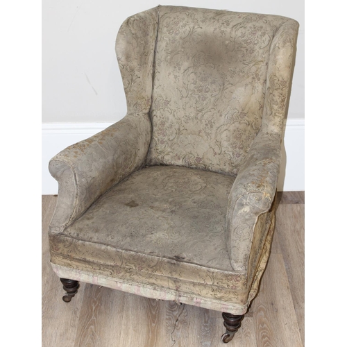 77 - A 19th century Howard style deep seated armchair with mahogany legs and castors, approx 90cm tall