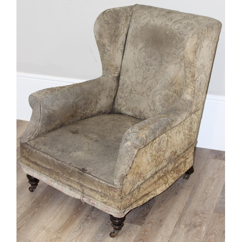 77 - A 19th century Howard style deep seated armchair with mahogany legs and castors, approx 90cm tall