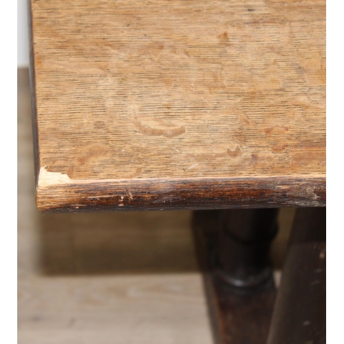 96 - An early 20th century oak refectory dining table with tuned wooden pillar supports, approx 168cm wid... 