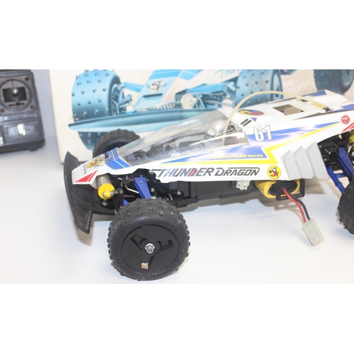 653 - A vintage Tamiya Thunder Dragon remote controlled car model kit, built but with box and controller e... 