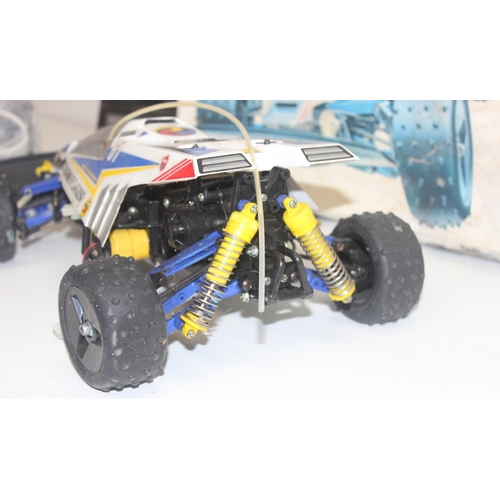 653 - A vintage Tamiya Thunder Dragon remote controlled car model kit, built but with box and controller e... 