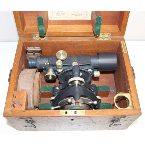 770 - A vintage Stanley theodolite in wooden case with leather strap and other accessories