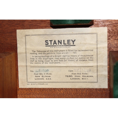 770 - A vintage Stanley theodolite in wooden case with leather strap and other accessories