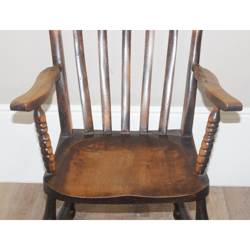 46 - An antique slat back farmhouse Windsor armchair and an antique upholstered bedroom chair with stick ... 