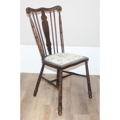 46 - An antique slat back farmhouse Windsor armchair and an antique upholstered bedroom chair with stick ... 