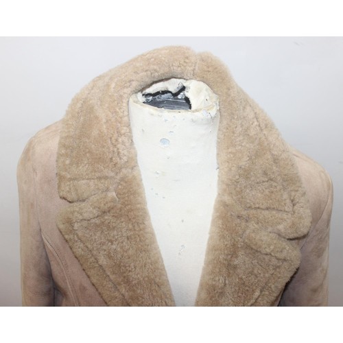 213 - A vintage Mary Quant waterproof poncho or cape, A vintage double-breasted sheepskin coat, label for ... 