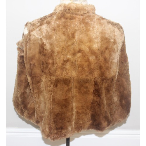 213 - A vintage Mary Quant waterproof poncho or cape, A vintage double-breasted sheepskin coat, label for ... 