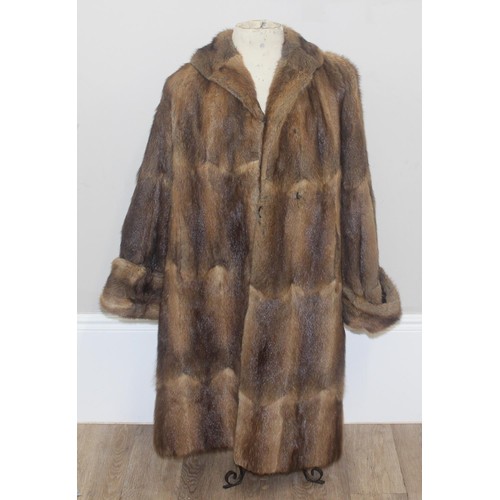 213 - A vintage Mary Quant waterproof poncho or cape, A vintage double-breasted sheepskin coat, label for ... 