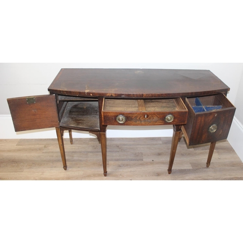 85 - A Georgian mahogany bow front sideboard, with frieze drawer flanked by a cupboard and a cellarette d... 