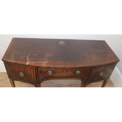 85 - A Georgian mahogany bow front sideboard, with frieze drawer flanked by a cupboard and a cellarette d... 