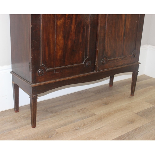 22 - A Georgian mahogany hall cupboard on stand, 2 large doors concealing 4 adjustable shelves, approx 11... 