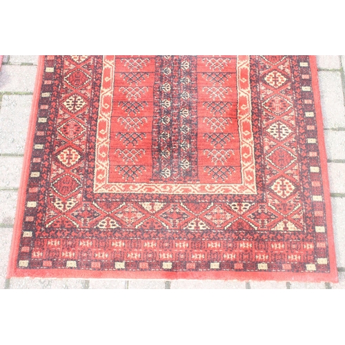 215 - A modern red ground rug by Super Taj, approx 160cm x 84cm, and one other