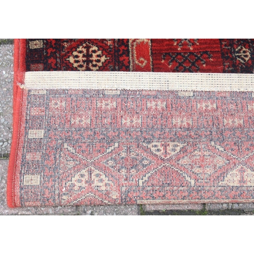 215 - A modern red ground rug by Super Taj, approx 160cm x 84cm, and one other