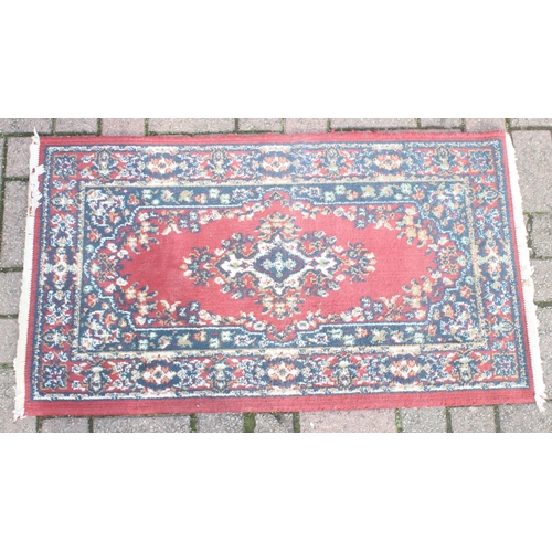 215 - A modern red ground rug by Super Taj, approx 160cm x 84cm, and one other