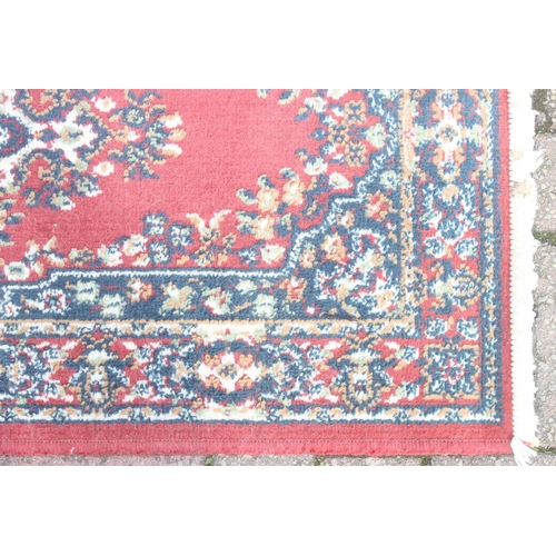 215 - A modern red ground rug by Super Taj, approx 160cm x 84cm, and one other