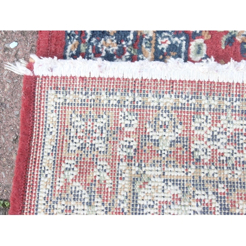 215 - A modern red ground rug by Super Taj, approx 160cm x 84cm, and one other