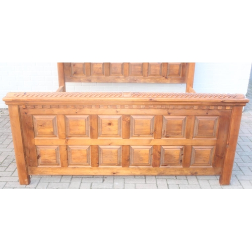 25 - A rustic panelled pine bed frame with twisted decoration, to fit a king size mattress, approx 128cm ... 